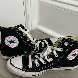 Black high top converse.